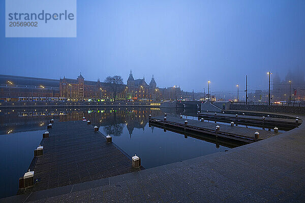 Amsterdam Railway Central Station and Basilica of St. Nicholas at blue hour