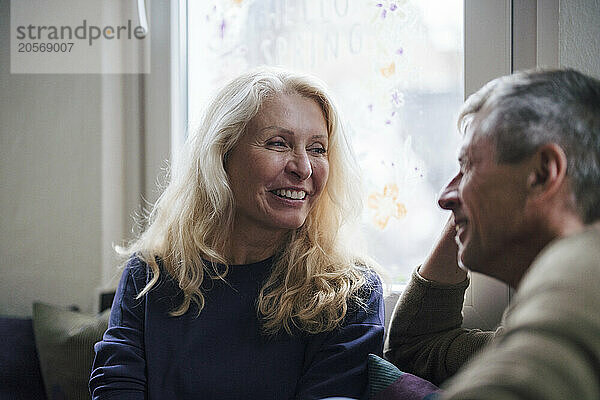 Happy retired senior woman looking at man