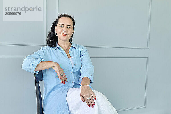 Confident businesswoman sitting on chair