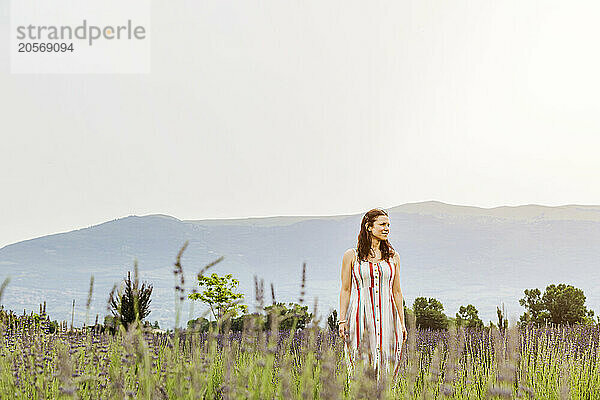 Woman walking on lavender field