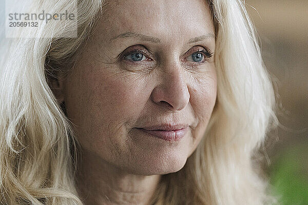 Blond retired senior woman looking away