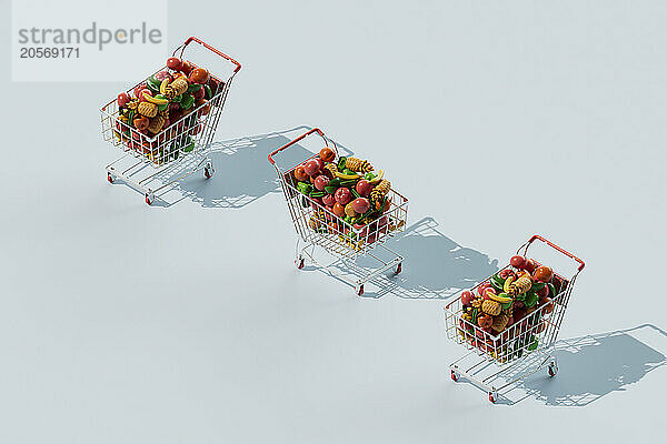 Shopping carts filled with colorful fruits and vegetables over blue background