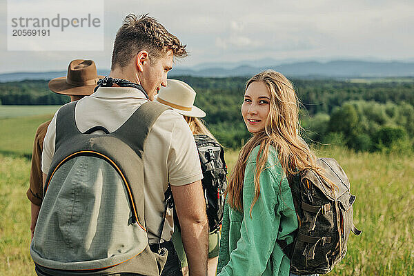 Beautiful woman hiking with friends on mountain in Poland