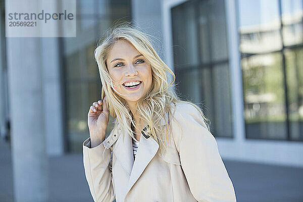 Happy blond woman wearing jacket