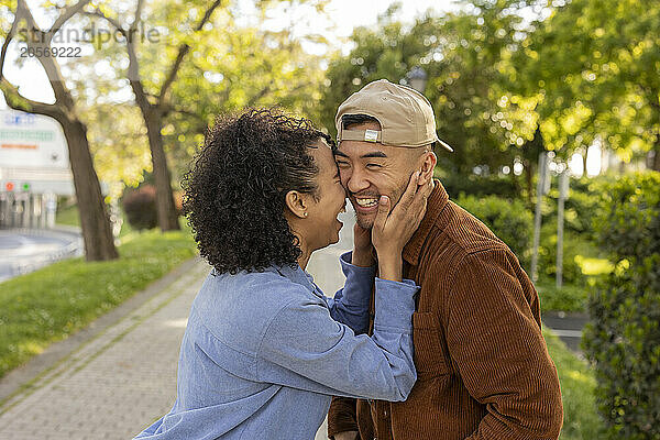 Happy girlfriend enjoying with boyfriend at park