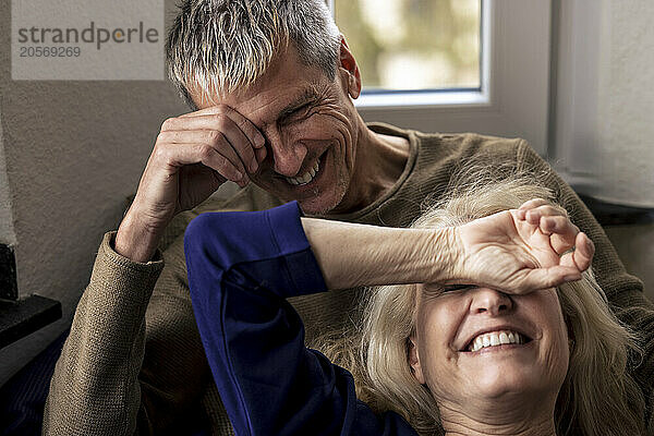 Cheerful senior couple relaxing together at home