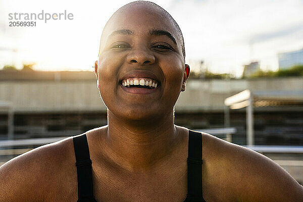 Happy bald woman on sunny day