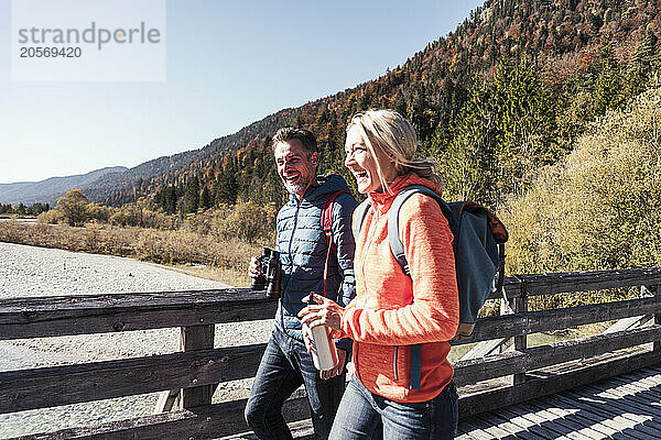 Cheerful couple walking on boardwalk