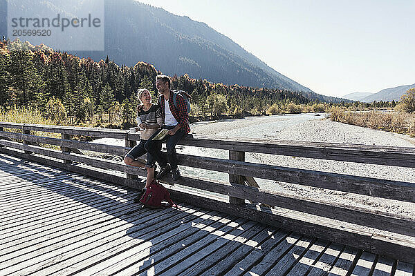 Couple on boardwalk in front of river at weekend