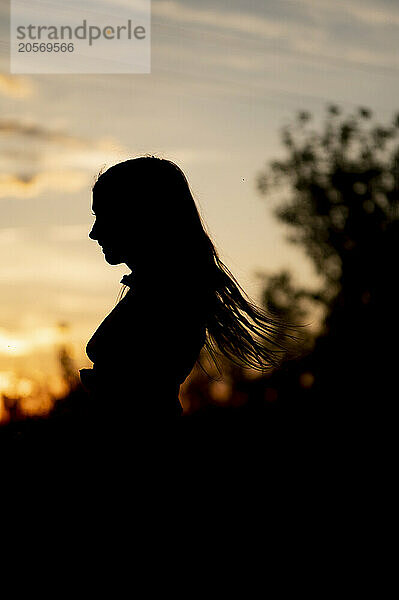 Silhouette of girl at sunset