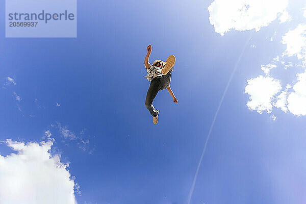 Man doing parkour in front of sky