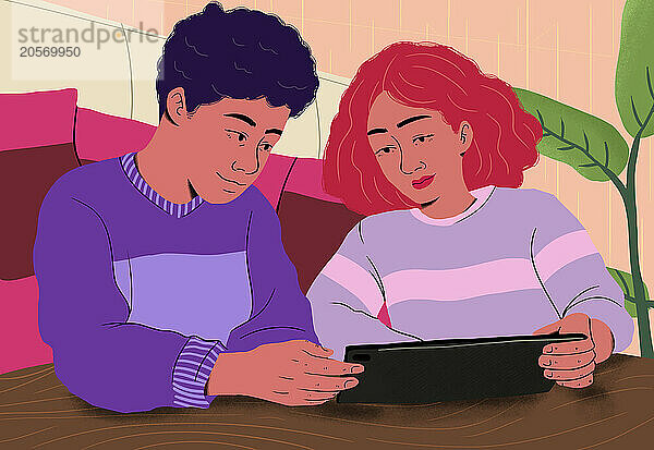 Boy and girl using tablet PC at table