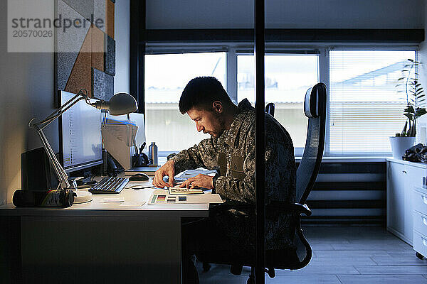 Fashion designer working at desk in workshop