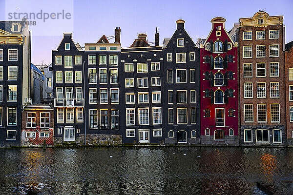 Dancing Houses near Amstel river at sunset