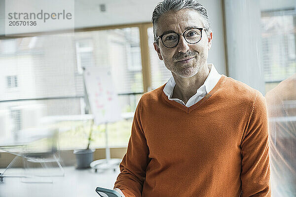 Confident mature businessman wearing eyeglasses at office