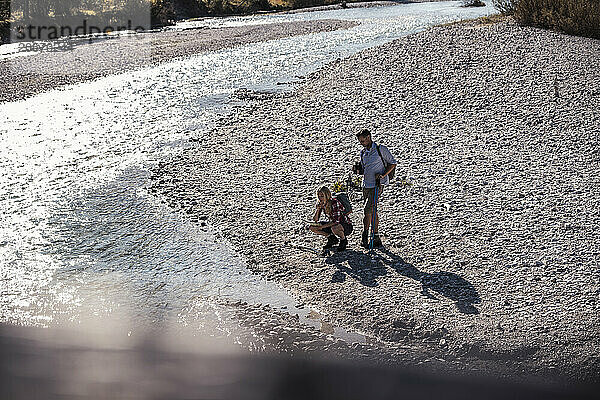 Friends near river on sunny day