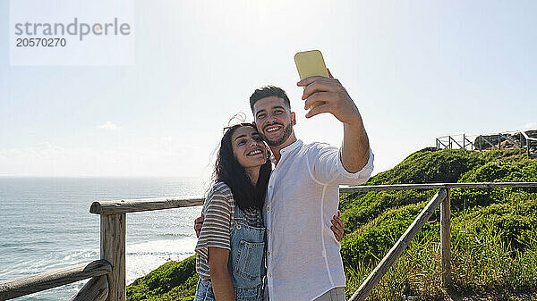 Young couple taking selfie through smart phone