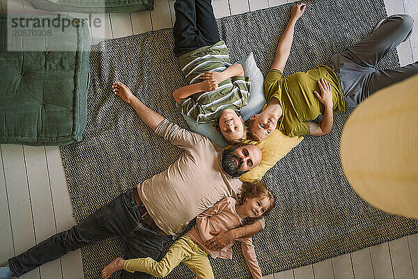 Family lying on carpet at home