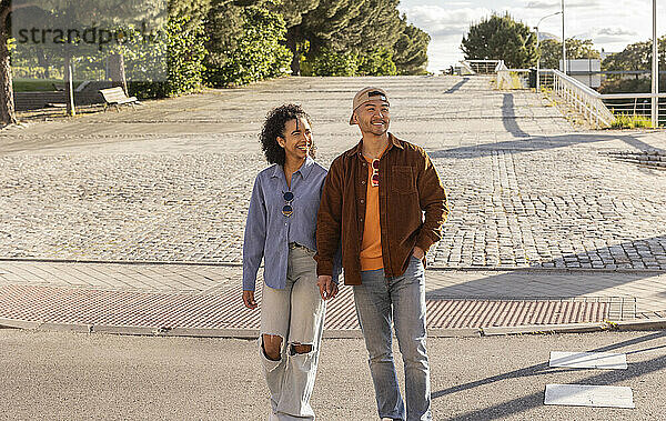 Happy young couple walking on street