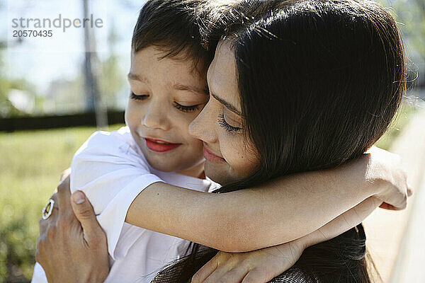 Mother and son embracing