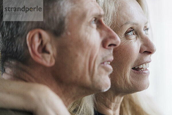 Retired senior couple looking away together