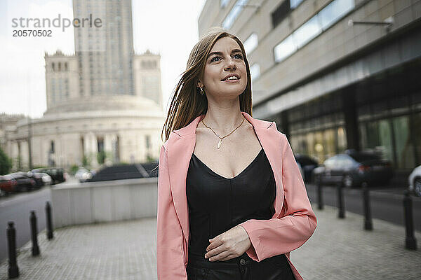 Thoughtful woman walking on street in Poland