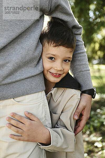 Smiling boy embracing father