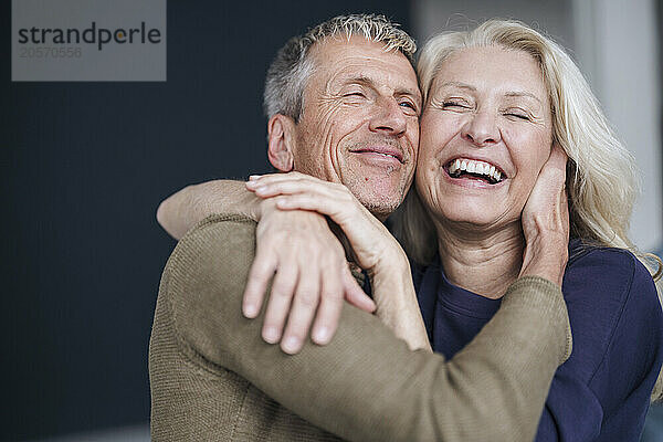 Happy retired senior couple hugging each other