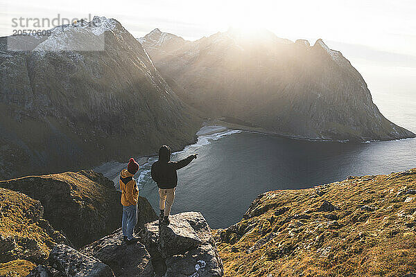 Friends together standing on rocks at Lofoten and Nordic islands  Norway