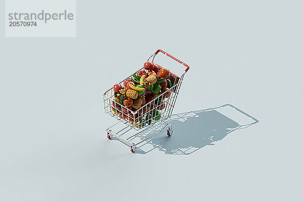 Shopping cart filled with colorful fruits and vegetables over blue background