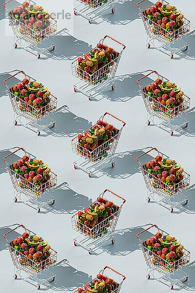 Seamless pattern of shopping cart filled with colorful fruits and vegetables against blue background