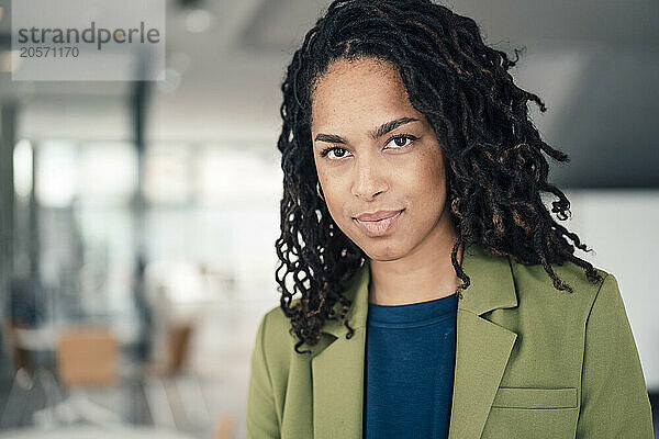 Confident young beautiful businesswoman at office