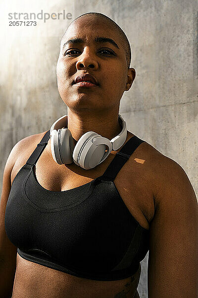 Confident sporty woman with headphones