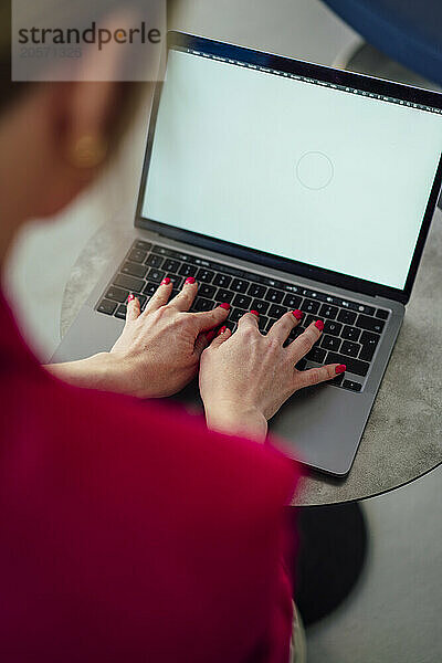 Businesswoman typing on laptop working at office