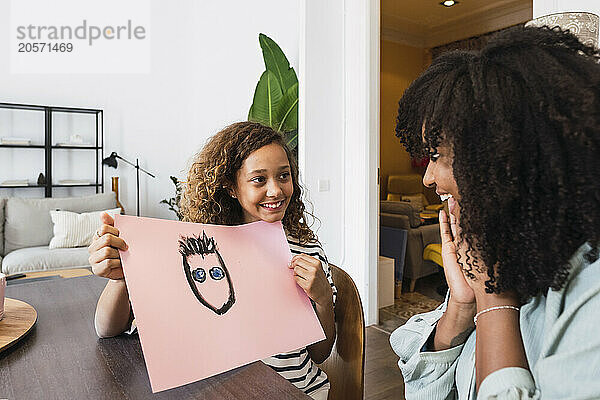 Daughter showing mother new painting