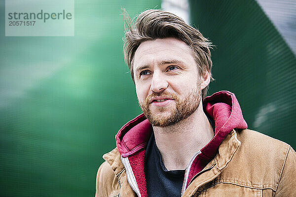 Thoughtful man in brown jacket