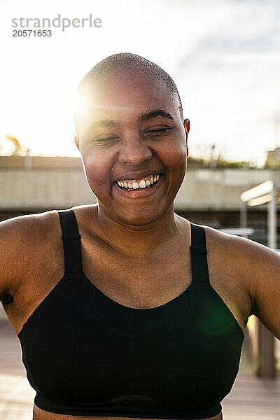 Cheerful bald woman on sunny day