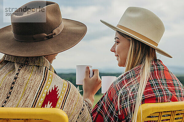 Young couple sitting and drinking tea