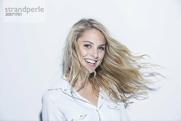 Happy blond woman against white background