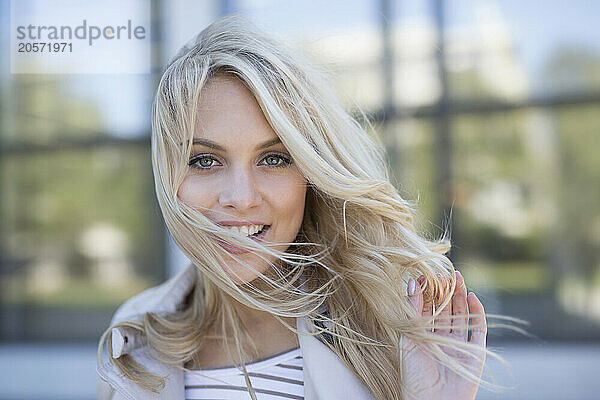 Smiling young woman with blond hair