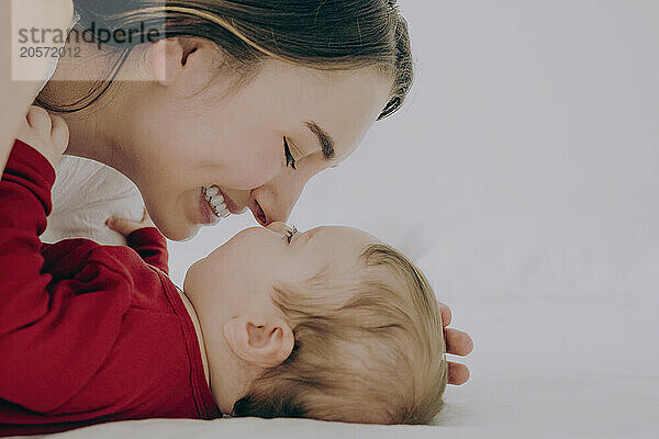 Mother and son rubbing noses at home