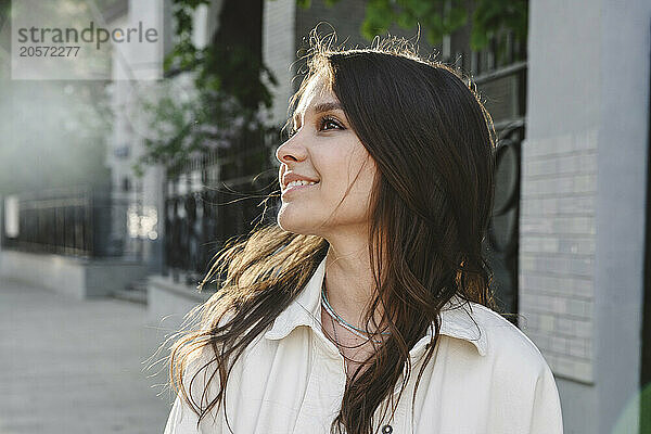 Smiling woman with long hair at street