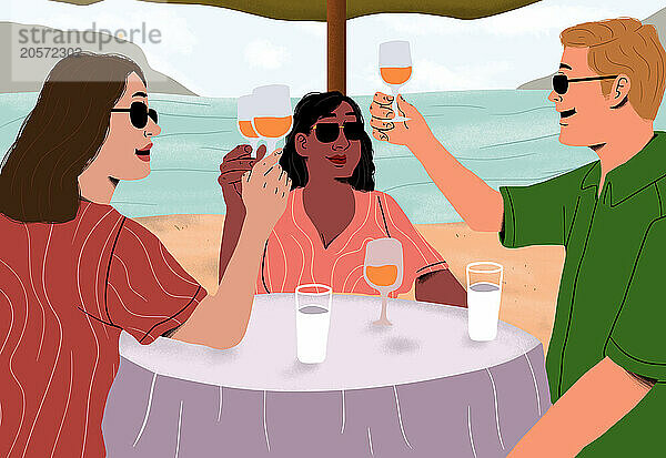 Diverse friends toasting wineglasses at table on beach