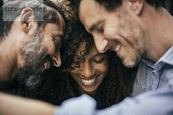 Business colleagues huddling with each other