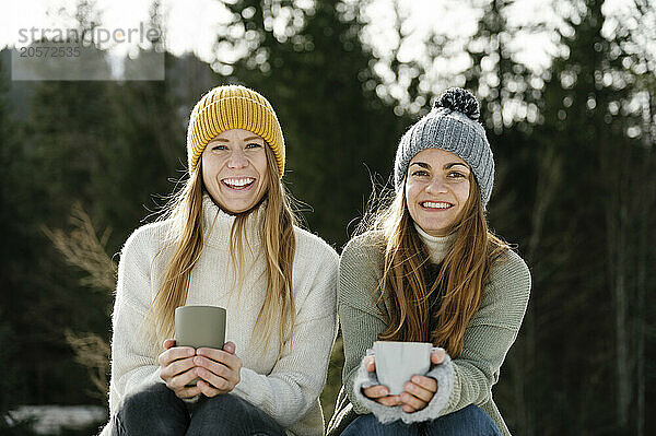 Happy friends enjoying coffee in winter