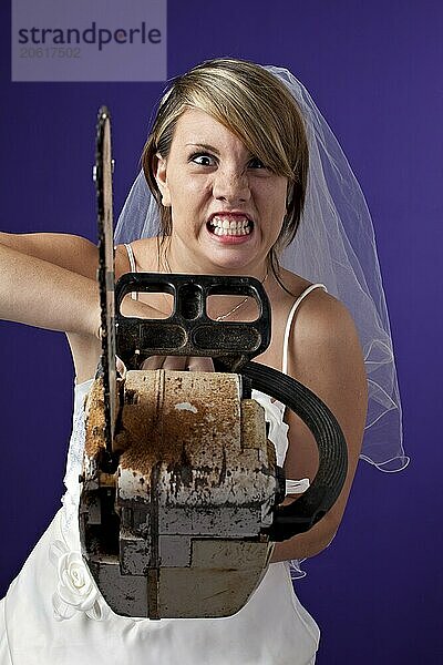 Angry young bride with an chainsaw on a dark blue background