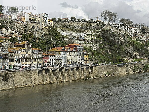 City view with colourful buildings on a hill and a riverside road along the river  Porto  Douro  Portugal  Europe