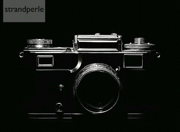 Vintage camera silhouette in the dark