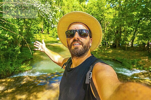 Selfie of a happy tourist right next to the waterfalls in the Monasterio de Piedra Natural Park  Aragon  Spain  Europe