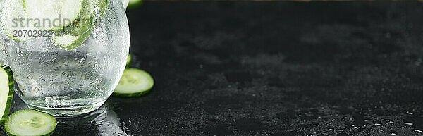 Portion of Cucumber Water as detailed close up shot on a slate slab  selective focus